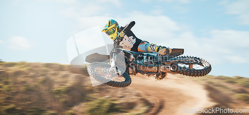 Image of Motorcycle, fearless man and motorcross jump in desert, blue sky and freedom. Driver, cycling and offroad freedom of sports competition, motorbike performance or adventure course for fast action show