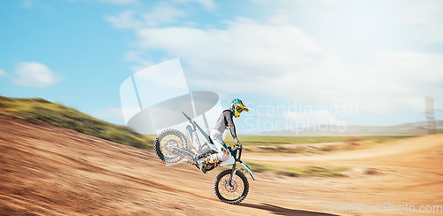 Image of Motorcross, offroad speed and sports on sky for freedom, action or fearless driving. Driver, cycling and power on dirt track, motorcycle competition and motorbike performance on fast adventure course