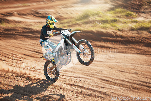 Image of Motorcycle, dirt track stunt and air jump in desert, sand trail and freedom. Driver, cycling and offroad freedom, sports competition and motorbike performance on adventure course for fast action show