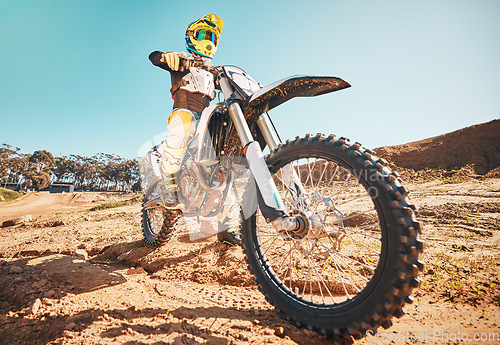 Image of Motorcross, motorcyclist and man in sports gear for challenge, offroad race and desert rally. Driver, bike and ready for dirt track competition, motorbike performance and action on adventure course