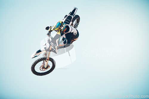 Image of Motorbike, outdoor jump and man on blue sky mockup for speed challenge, sports risk and fearless skill. Driver, air stunt and biker with energy, freedom and performance talent of motorcycle adventure