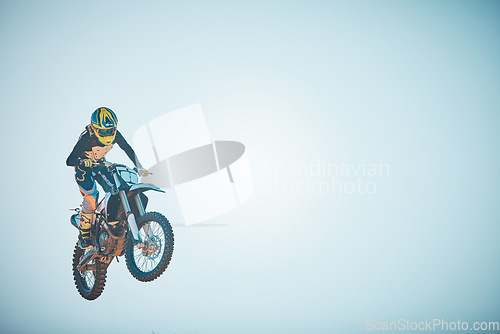 Image of Bike, motorcycle and jump on blue sky mockup for speed challenge, sports and fearless risk. Driver, air stunt and driving with adrenaline in competition performance, adventure and fast motorbike race