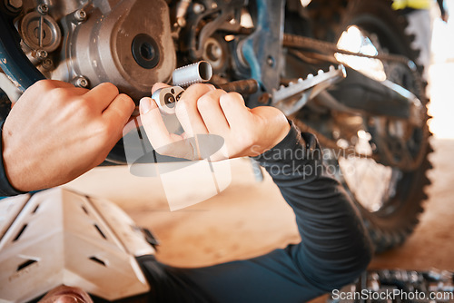 Image of Hands, mechanic and engine gear repairs working on motor with tools for safety or mechanical parts. Hand of engineer fixing motorbike, transport or transmission on automobile or vehicle in workshop