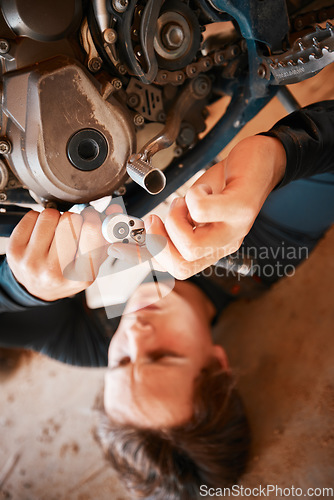 Image of Hands, mechanic and engine gears in motor repairs with tools for bolts, safety or mechanical parts. Hand of engineer fixing motorbike, transport or transmission on automobile or vehicle in workshop