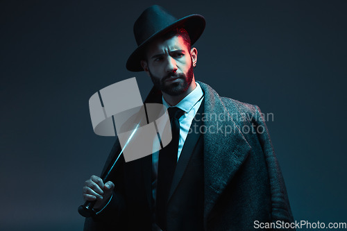 Image of Fashion, criminal and face of man with bat for vintage, retro and Victorian gangster on dark background. Crime aesthetic, thinking and male model with luxury, designer suit and threatening attitude