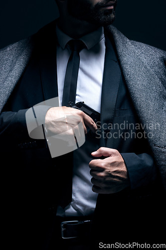 Image of Bodyguard, hands or gun in suit jacket on studio background in dark secret spy or isolated mafia leadership. Gangster, man or criminal hiding weapon in formal, crime lord or fashion clothes aesthetic