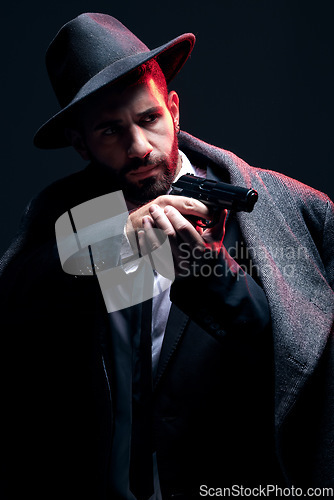 Image of Bodyguard, suit or shooting gun on studio background in dark secret spy, isolated mafia leadership or crime lord security. Model, man and gangster aiming weapon in formal or fashion clothes aesthetic