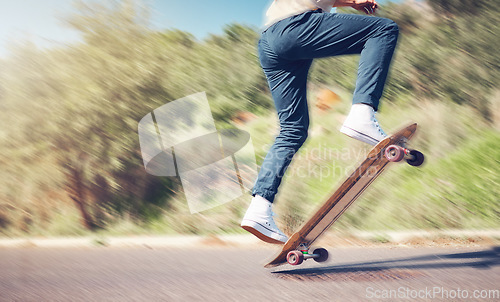 Image of Sports, skill and man on a skateboard in the road for an outdoor hobby, training or exercise. Gen z, blur motion and male skater or athlete skating in the street for a fitness workout in nature.