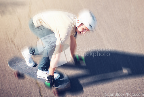 Image of Skate, motion blur and speed with a sports man skating on a road outdoor from above. Skateboard, soft focus and fast with a young male athlete or skater training outside on an asphalt street