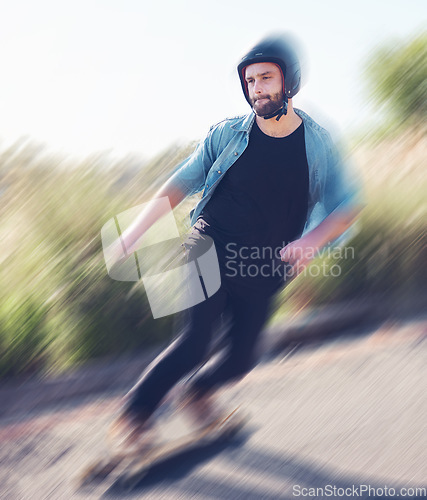 Image of Motion blur, skateboard and balance with a sports man training outdoor on an asphalt street at speed. Skating, speed and movement with a male skater on a road for fun, freedom or training outside