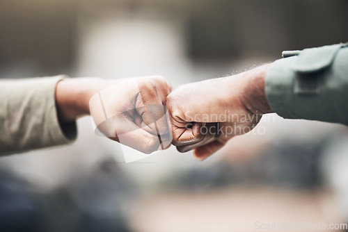 Image of People, hands and fist bump for agreement, deal or trust in partnership, unity or support on a blurred background. Hand of team touching fists for community, teamwork or collaboration in the outdoors