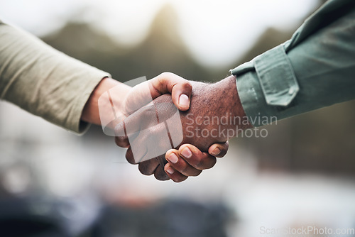 Image of People, hands and handshake for deal, trust or agreement in partnership, unity or support on a blurred background. Hand of team shaking hands for community, teamwork or collaboration in the outdoors