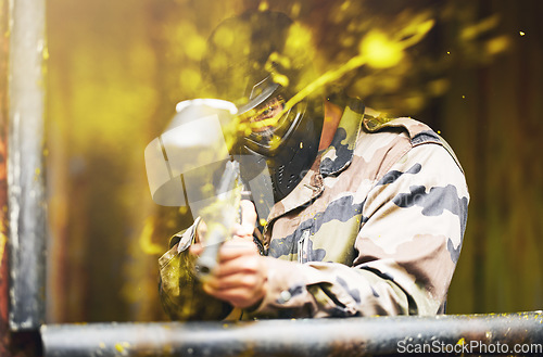 Image of Paintball, soldier and camouflage with a sports man playing a military game for fun or training outdoor. War, gun and target with a male athlete shooting a weapon outside during an army exercise