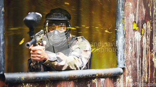 Image of Paintball, gun and soldier with a sports man playing a military game for fun or training outdoor. War, camouflage and target with a male athlete shooting a weapon outside during an army exercise