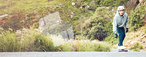 Image of Skateboard, nature and mockup with a sports man on an asphalt street skating through the mountains. Skater, green and mock up with a male athlete skateboarding on a road alone in the wilderness