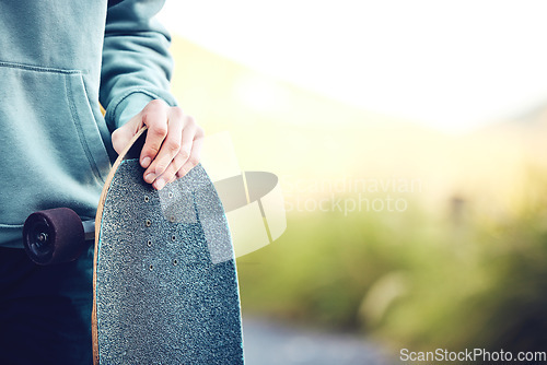 Image of Skateboard, sports and hands of man in park ready for adventure, skateboarding and fitness in city. Copy space, mockup and male skater with longboard for exercise, skating and training outdoors