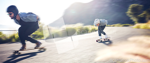 Image of Sports, speed and fast longboard skating in road, friends racing downhill with skateboard and helmet for safety. Extreme sport adventure, skateboarding street race and skateboarder on mountain pass.