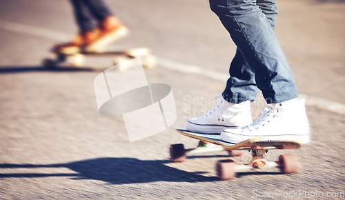 Image of Street, feet on skateboard and friends skating at skatepark with speed, skill and balance on road. Freedom, urban fun and gen z skateboarder hobby, legs and skate trick skateboarding for transport.