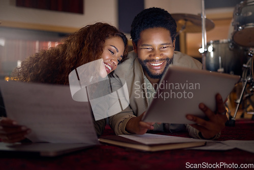 Image of Streaming music, musician and couple with a tablet for an app, funny video and performance idea in dark. Laughing, creative and artist, song writer or black man and woman with tech for inspiration