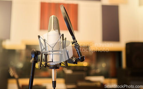 Image of Music, media and rock with microphone in studio for recording, performance and audio. Radio, technology and sound with electronics equipment in empty room for broadcast, singing and entertainment
