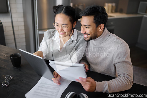 Image of Finance, budget and asian couple on tablet at home working on mortgage documents, financial feedback or loan. Happy, smile or people on tech for internet banking, accounting review or audit research