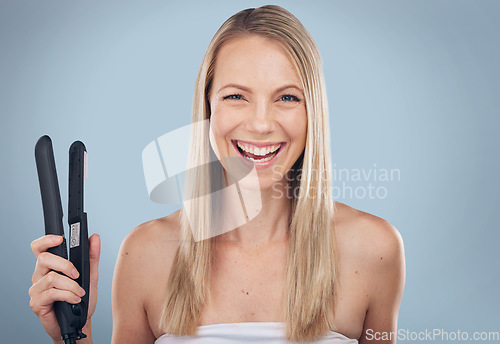 Image of Hair straightener, face portrait and woman in studio isolated on a gray background. Beauty, haircare and laughing female model holding flat iron product for hairstyle, grooming and salon treatment.