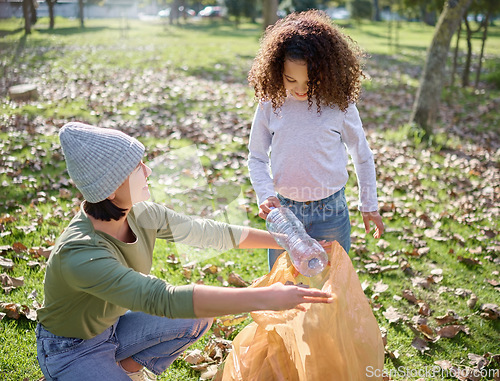 Image of Trash, volunteer woman and child cleaning garbage, pollution or waste product for community environment support. Plastic bag container, NGO charity and eco friendly kid help with nature park clean up