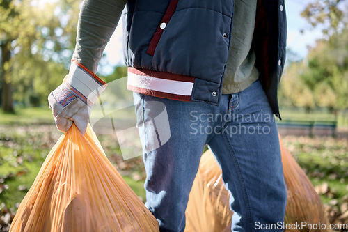 Image of Trash, volunteer hands and man cleaning garbage, pollution or waste product for environment support. Plastic bag container, NGO charity service and eco friendly person help with nature park clean up