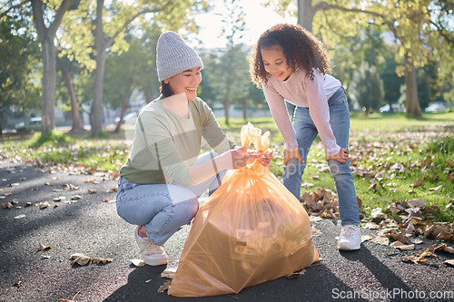 Image of Trash, volunteer woman and kid cleaning garbage, pollution or waste product for environment community service. Plastic bag container, NGO charity and eco friendly child help with nature park clean up