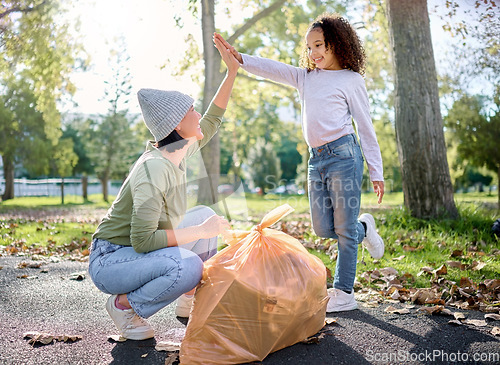 Image of High five, volunteer woman and kid cleaning garbage pollution, waste product or community environment support. Teamwork celebration, NGO charity and eco friendly child done with nature park clean up