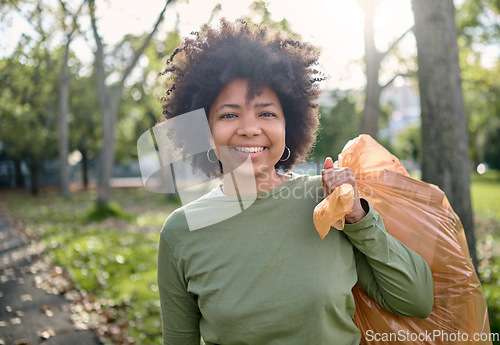 Image of Trash, volunteer portrait and black woman cleaning garbage pollution, waste product or environment support. Plastic bag container, NGO charity and eco friendly person help with nature park clean up