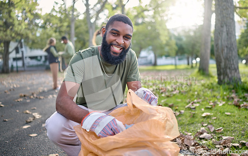 Image of Black man, volunteer portrait and plastic bag for community park cleanup, recycling or cleaning. Ngo person outdoor in nature to recycle, earth day or happy about a clean from pollution enviroment