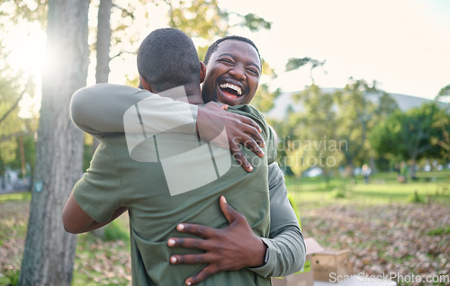 Image of Charity, happy and hug with volunteer friends in a park for community, charity or donation of time together. Support, teamwork or sustainability with a black man and friend hugging outdoor in nature