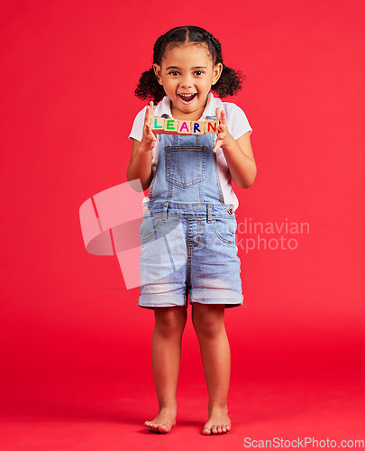 Image of Learn blocks, education and portrait of child on red background for learning, reading and kindergarten. Child development, knowledge and excited, happy and young girl smile with letters on wood toys