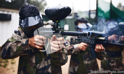 Image of Paintball game, gun smoke and men in war, competition or sports challenge outdoor for target shooting. Military, soldier or army group doing teamwork training mission in woods with people or friends