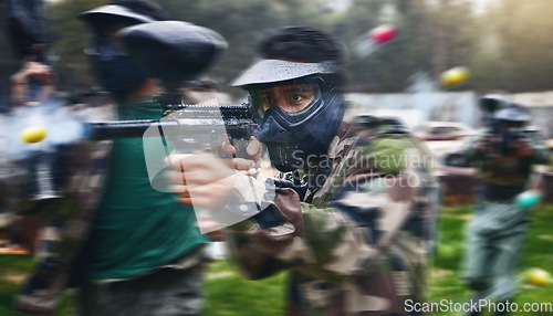 Image of Paintball gun, shooting and men in camouflage with safety gear at military game for target practice. Teamwork, sports training and war games, play with rifle and friends working together at army park