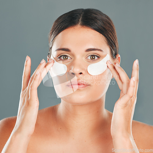 Image of Beauty, eye patch and portrait of woman face, skincare and dermatology on studio background. Female model, facial and eye care gel for dark circles, body cosmetics and wellness of collagen treatment