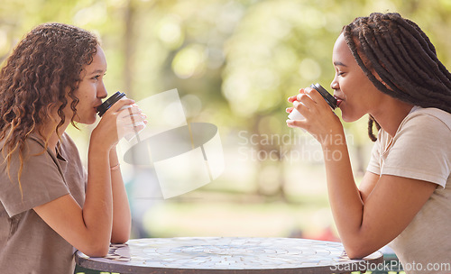 Image of Woman, friends and drinking coffee on table at cafe in social life, catchup or communication outside. Happy women enjoying friendly discussion, talk or drink together in friendship at restaurant shop