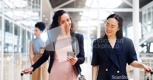 Image of Business woman, phone and walking with luggage in travel for work trip partnership at the workplace. Happy women talking or chatting on a walk to the airport for opportunity or journey with suitcase