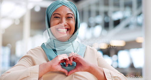 Image of Face, hands and heart with a muslim businesswoman walking in her office while happy at work. Portrait, laughing or smile with an islamic and carefree woman employee taking a walk while working