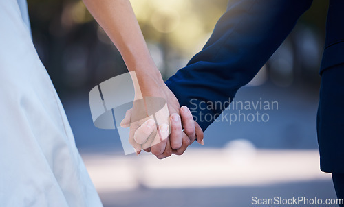 Image of Love commitment, wedding and couple holding hands outdoors for support. Partnership, diversity and affection, care or romance of interracial man, woman or bride and groom at ceremony for marriage day