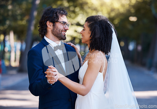 Image of Interracial wedding, couple and dancing in street with excited smile, happiness or future. Black woman bride, man and diversity at outdoor marriage for love, dance or eye contact in sunshine by trees