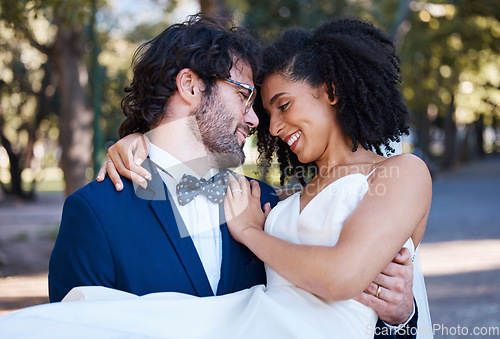 Image of Wedding, couple and marriage outdoor with love, commitment and trust with bride and groom in park. Happiness, life partner and interracial relationship with black woman and man, hug and married