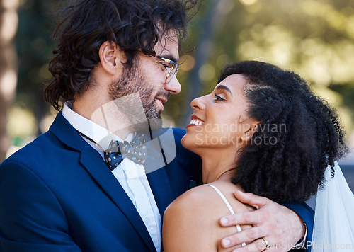 Image of Happy couple, love and wedding celebration event together with commitment, care and support. Interracial man and woman at park with trust, marriage partnership and a hug with a smile on their face