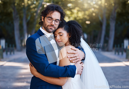 Image of Wedding, hug and love of a couple outdoor for marriage celebration event, commitment and care. Interracial man and woman at park with trust, partnership and embrace for gratitude for life partner