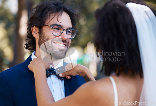 Image of Wedding, happy couple and bow tie outdoor at marriage celebration event together with care. Smile of groom and bride at a park with love, partnership and support or commitment while helping with suit