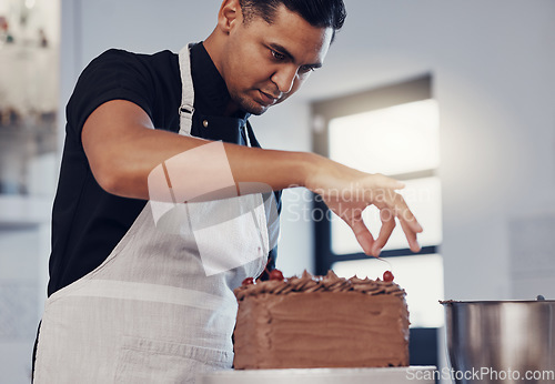Image of Kitchen, baking and man decorating cake with chocolate sprinkles and frosting with focus and skill. Sweets, small business and baker decorating dessert for birthday event and pastry chef in bakery.