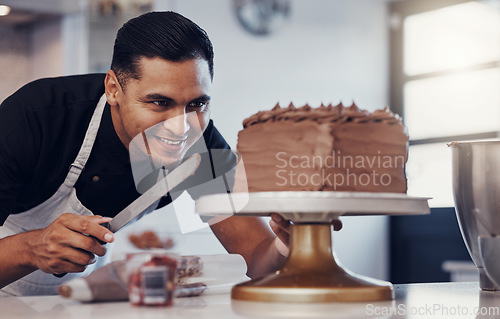 Image of Baking, small business and happy man icing cake with chocolate frosting and piping bag in bakery with smile. Sweets, skill and baker decorating dessert for birthday event and chef working in kitchen.