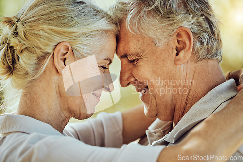 Image of Senior couple, face and forehead touch with love, care or commitment in retirement. Happy man, elderly woman and pensioner hug of romance, smile or happiness together in marriage relationship at park