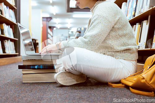 Image of Books, laptop or student typing on library floor for research, knowledge or development for future growth. Online project, university or school girl studying or learning college information on campus